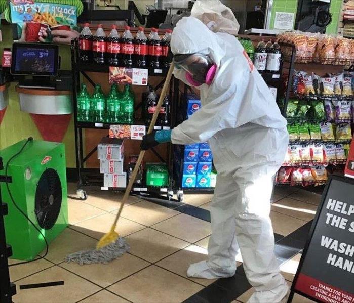 Employee mopping up water.